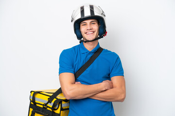 Young caucasian man with thermal backpack isolated on white background keeping the arms crossed in...