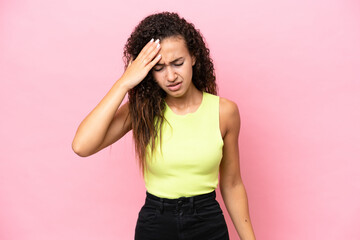 Young hispanic woman isolated on pink background with headache