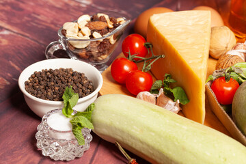 Vegetables and cheese on a wooden background.