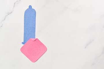 Condom, contraceptive method concept and sexual education.