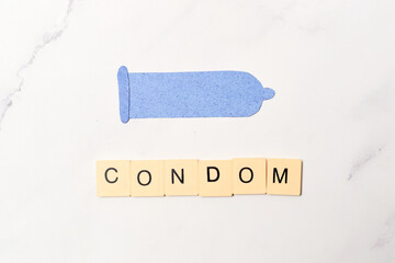 Condom, contraceptive method concept and sexual education.
