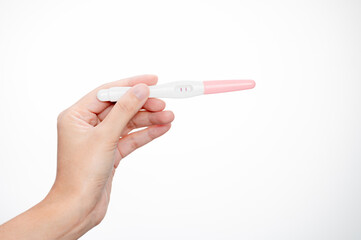 Woman hand holding pregnancy test showing a negative. Concept  treatment IUI Intra – Uterine Insemination and ICSI.