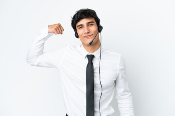 Telemarketer man working with a headset isolated on white background doing strong gesture