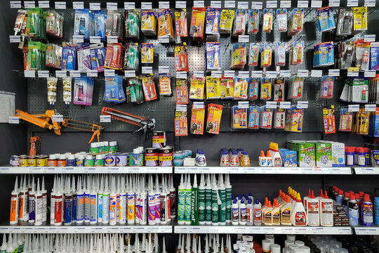 PENANG, MALAYSIA - 18 JUNE 2022: Various choice of glue stick, tube and bottle display in HomePro store. HomePro is a hypermarket of home product and building construction in Malaysia.  