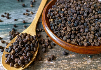black pepper in a wooden spoon