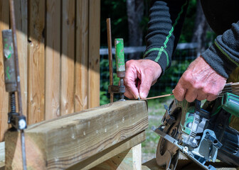 the work of a carpenter, men's hard-working hands in the process of creating wooden structures