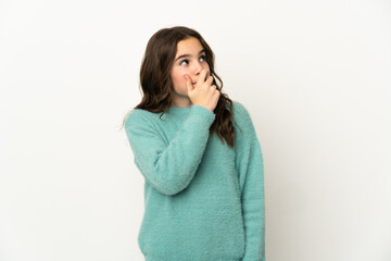 Little caucasian girl isolated on white background having doubts and with confuse face expression