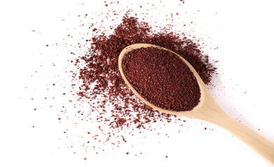 Ground sumac spice, pile in wooden spoon isolated on white, top view 