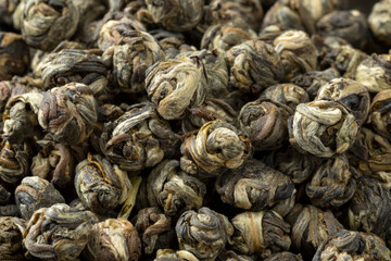 Chinese Jasmine Dragon pearl tea close up full frame as background 