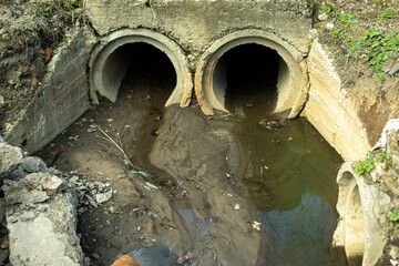 Pipes drain waste. Sewerage in city. Concrete pipes in ground.