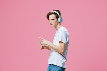 handsome guy listening to music in his headphones while dancing