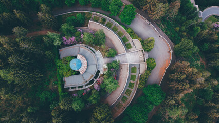 Aerial high angle view of The Monumental Cemetery of Craviolo, in the Province of Biella, Piedmont, Italy. Semicircular architecture plan. Building surrounded by nature.