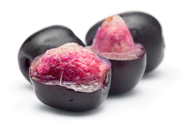 Close-Up of collection of Indian Ayurvedic medicinal fresh organic fruit jamun (Syzygium Cumini) or black plum, with peeled seed , half cut fruit,  isolated in white background.