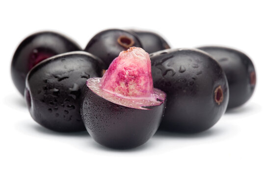 Close-Up of collection of Indian Ayurvedic medicinal fresh organic fruit jamun (Syzygium Cumini) or black plum, with peeled seed , half cut fruit,  isolated in white background.