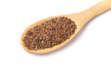Brown linseed on a spoon isolated over white background