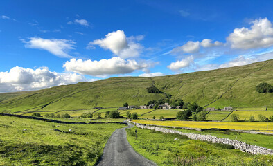 Yorkshire Dales landscape, descending from, Malham Moor, toward the picturesque village of, Halton...