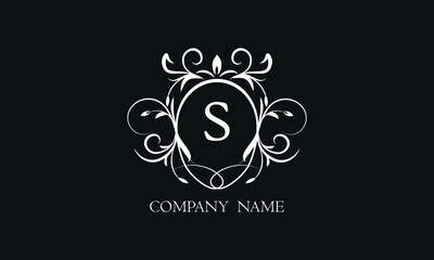 Elegant floral monogram with decorative elements and the letter S. Template for invitations, labels, business. Wedding monograms. Exquisite calligraphic ornament.