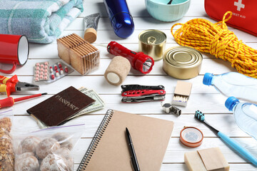Disaster supply kit for earthquake on white wooden table