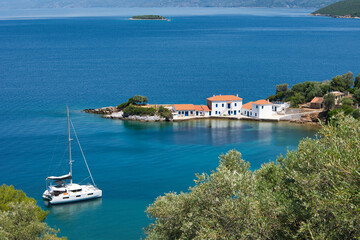 Wonderful Greek landscape, traditional house in front of a small bay and an olive grove that touches the sea. Pelion, Trikeri, Greece