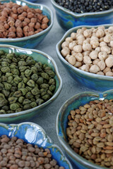 Assortment of dry chickpea and lentils in bowls.