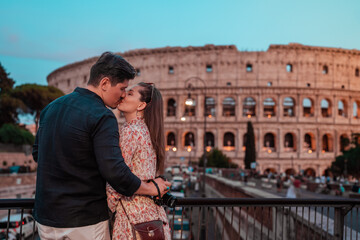 portrait of a couple in love in front of the roman colosseum