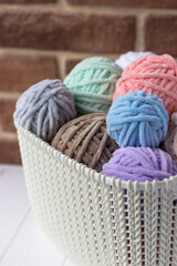 Plush yarn. Basket with tangles of thread. Knitting Day in Public