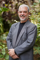 Senior professor in business suit smiling
