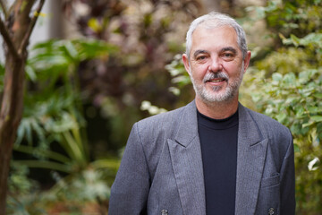 Senior professor in business suit smiling