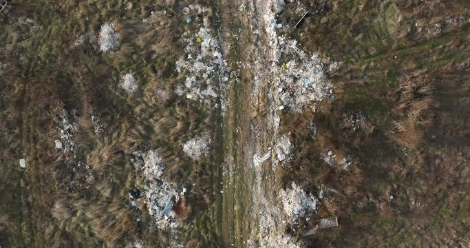two people walking on a huge aste, garbade, dump, rubbish landill in Bucharest