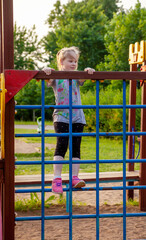 A young girl in the park on the playground