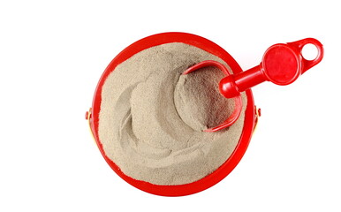 Plastic bucket, shovel and sand isolated on white, top view