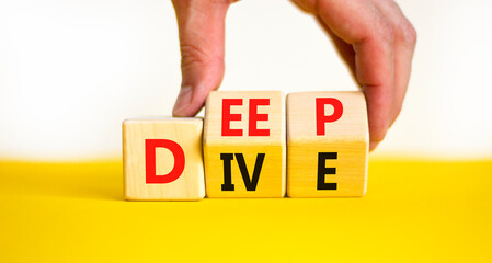 Deep dive symbol. Concept words Deep dive on wooden cubes. Beautiful yellow table white background. Businessman hand. Deep dive and business concept. Copy space.