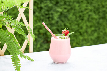 Strawberry banana milkshake or smoothie garnished with a strawberry and a mint leaf. Refreshing...
