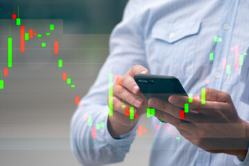 Fototapeta na wymiar Trader or investment checking market stock exchange chart on mobile phone.