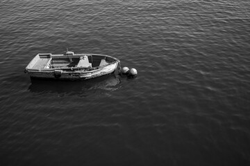 ship docked in port with calm sea in black and white