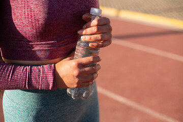 Close up de mano de mujer sosteniendo una botella de agua. Concepto de deporte y estilo de vida.