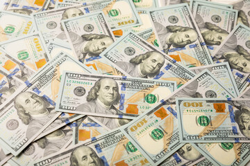 Money, US hundred dollar bills background on white wooden background. Money is scattered on the table. Finance and economics concepts.Money accumulation concept.Currency saving.Investment.Copy space.