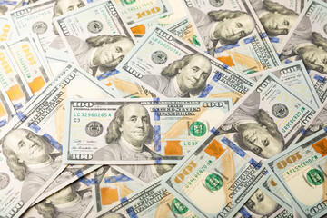 Money, US hundred dollar bills background on white wooden background. Money is scattered on the table. Finance and economics concepts.Money accumulation concept.Currency saving.Investment.Copy space.