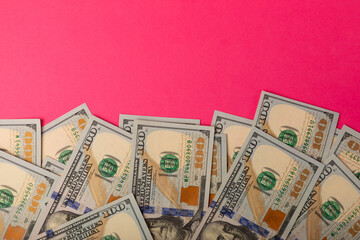 Money, stacks of US hundred dollar bills on a pink background. Money is scattered on the table. Concepts of finance and economics. Money saving concept. currency savings. Investments. copyright.