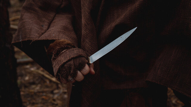 Hand gripping knife in a threatening manner