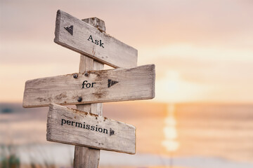ask for permission text quote on wooden crossroad signpost outdoors on beach with pink pastel sunset colors. Romantic theme. - obrazy, fototapety, plakaty