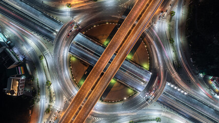 Aerial top view road roundabout interchange in city at night, Aerial view of highway and overpass...