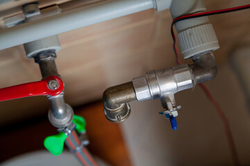 Two taps on plastic water pipes. View from above