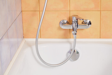 Steel mixer close-up on  modern bathtub