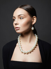 Beautiful young woman with pearl jewelry