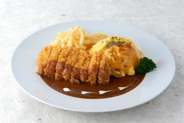 Tonkatsu Omu Rice served in a dish isolated on wooden table background side view of singapore food