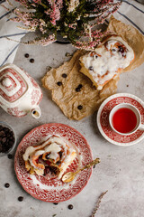 Cinnabon roll with great cream on it as it is inside with a great background