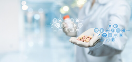 Doctor showing pills in front of virtual screen.