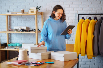 Small business owner, entrepreneur, seller with tablet in hand analyze sales, new orders to be sent...