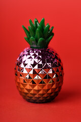 shiny decorative pineapple on red background